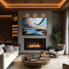 Abstract seascape painting in lounge with glowing fireplace