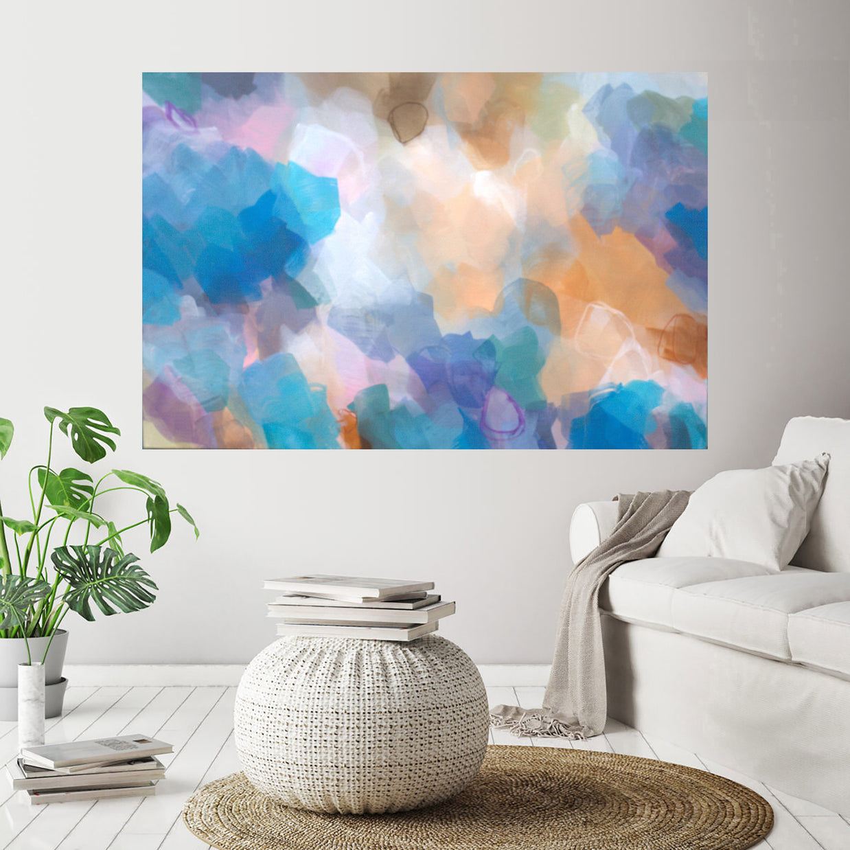 Colorful abstract painting on a wall above a white sofa and coffee table in a living room.