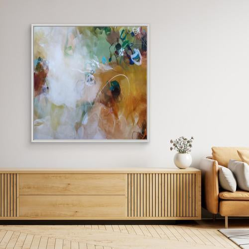 Abstract painting on a wall above a wooden console table in a living room.