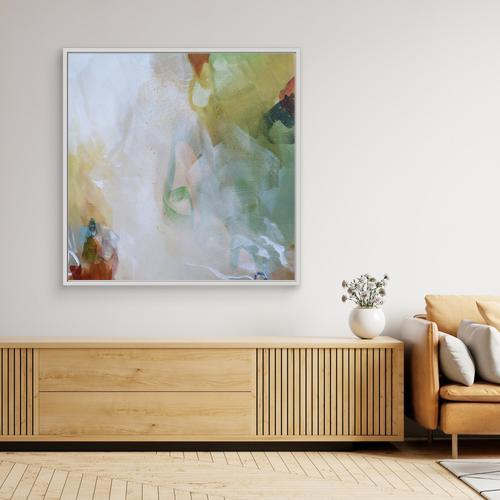 Modern living room with abstract art, wooden sideboard, and sofa.