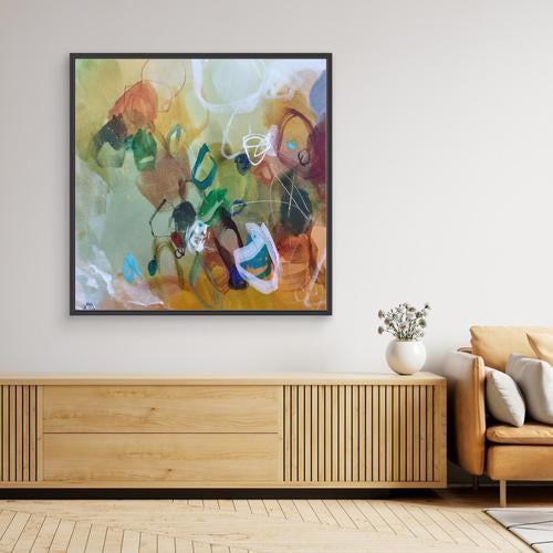 Modern living room with abstract painting, wooden cabinet, and sofa.