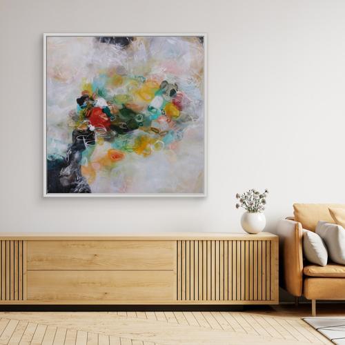 Modern living room with a colorful abstract painting on the wall, wooden sideboard, and beige sofa.