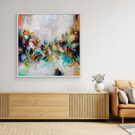 Modern living room with abstract painting, wooden cabinet, and sofa.