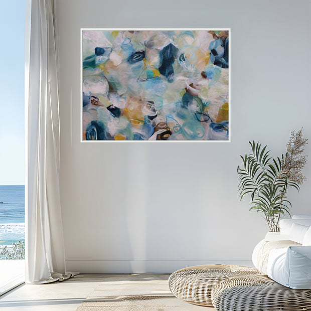 Abstract art print on a wall with a coastal view