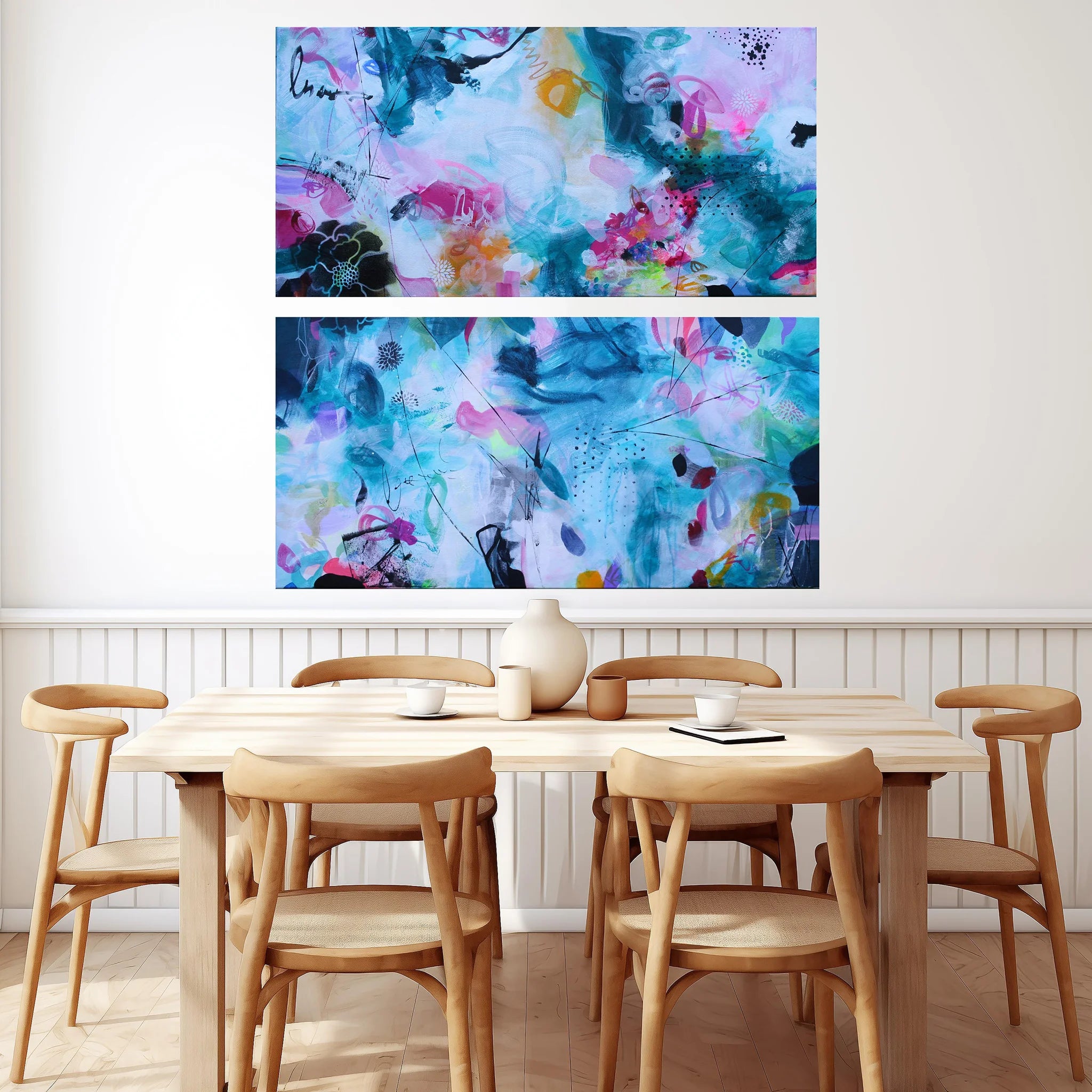 Dining room with wooden table and chairs, and abstract art on the wall.