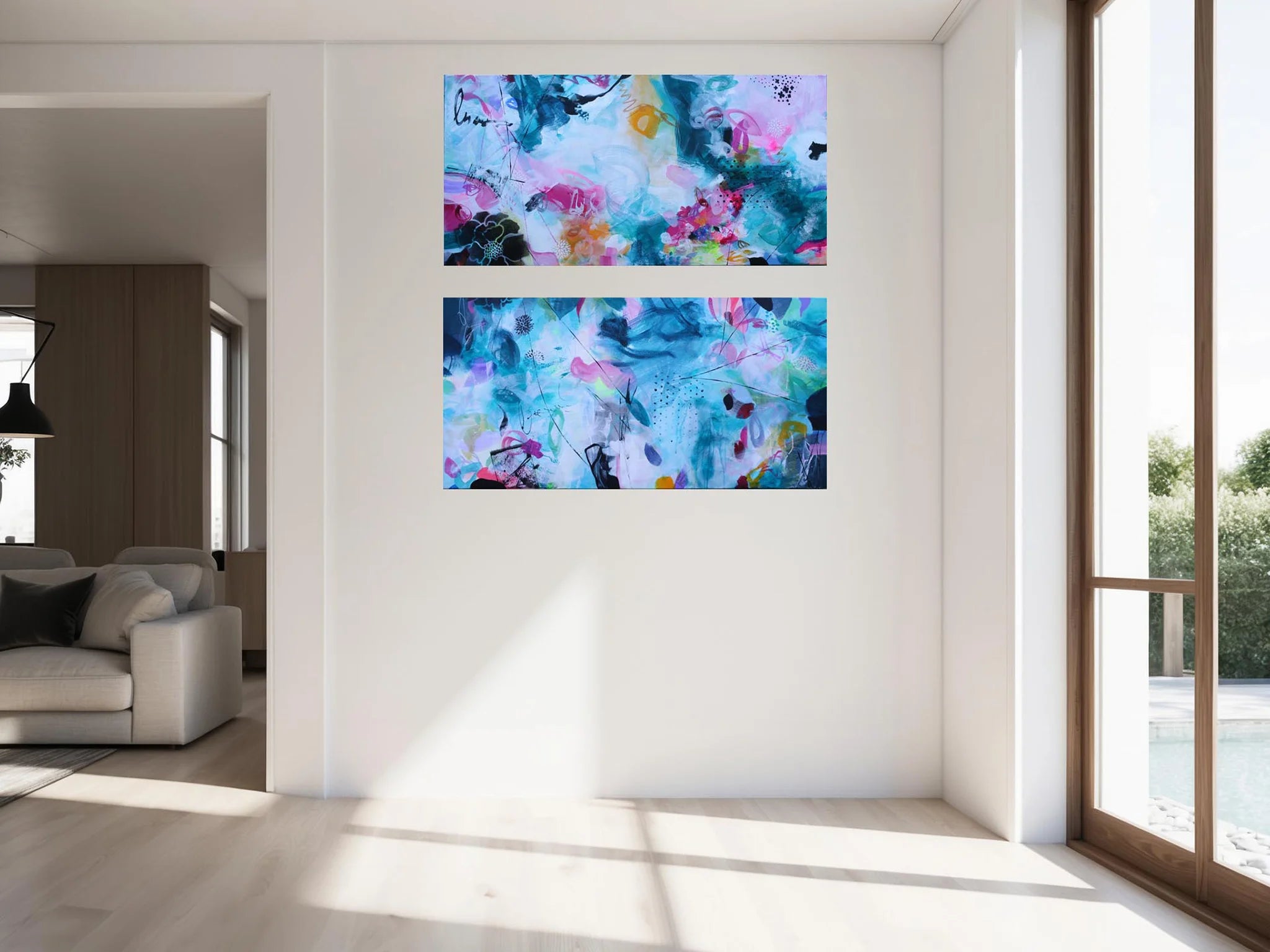 Two abstract paintings on a wall in a bright living room.