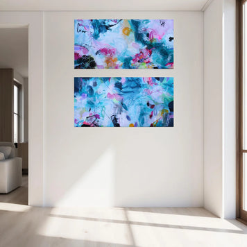 Two abstract paintings on a wall in a bright living room.