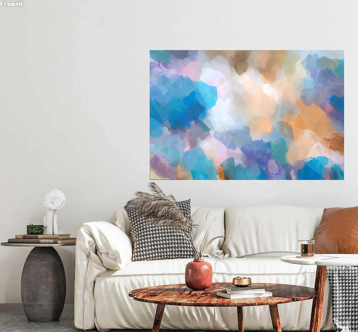 Living room with a white sofa, decorative pillows, and a colorful abstract painting on the wall.