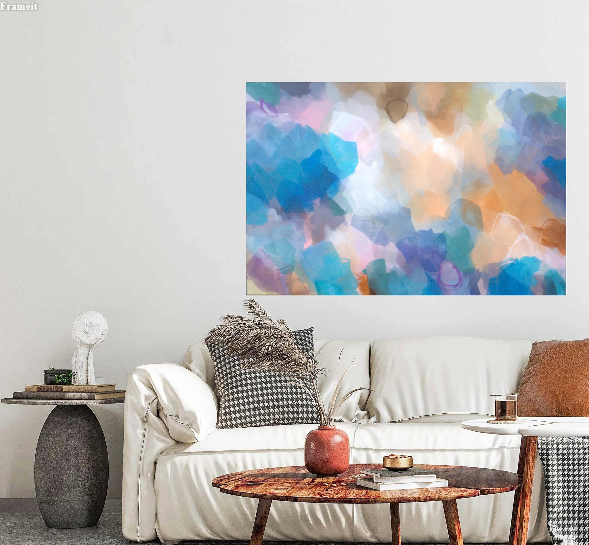 Living room with a white sofa, decorative pillows, and a colorful abstract painting on the wall.