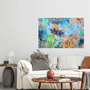 Colorful abstract painting on a wall above a white sofa with decorative pillows.