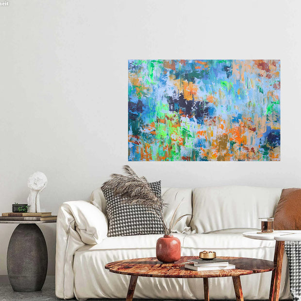 Colorful abstract painting on a wall above a white sofa with decorative pillows.
