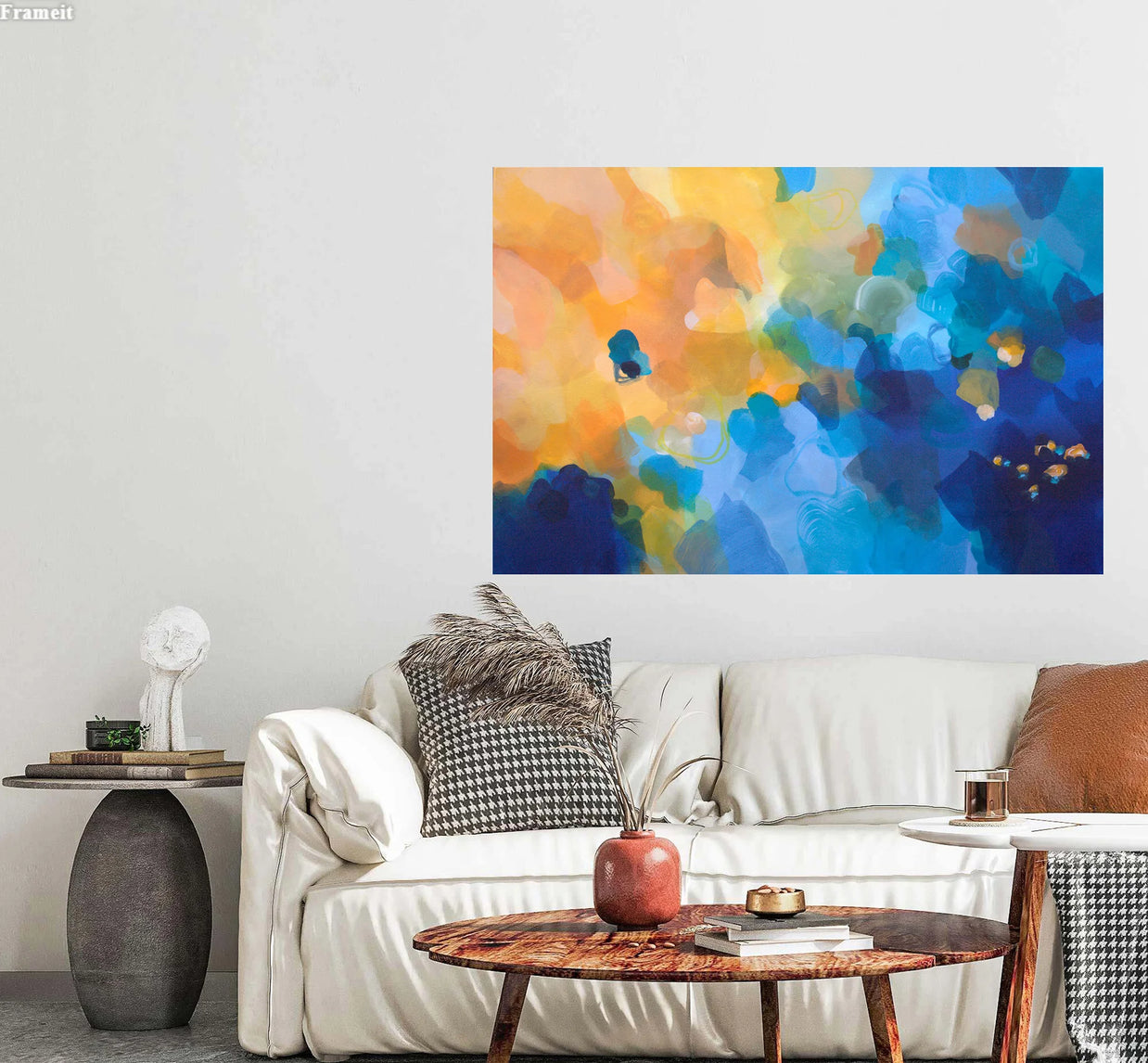 Colorful abstract painting on a wall above a white sofa with decorative pillows.
