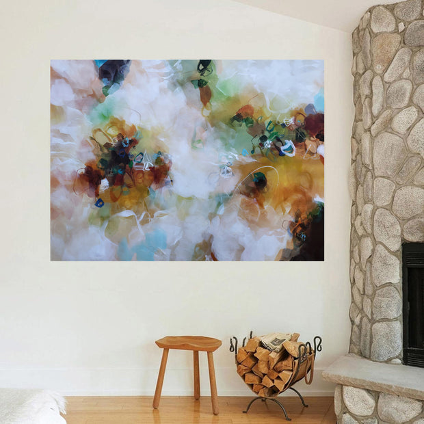 Abstract painting on a wall above a wooden stool and firewood basket.