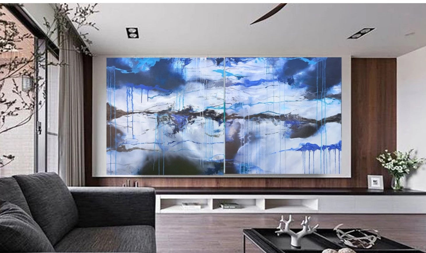 Modern living room with a large abstract painting on the wall.