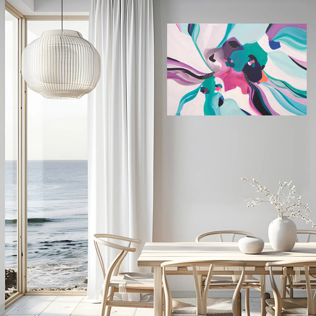 Modern interior with a colorful abstract painting on the wall, a dining table, and a view of the ocean.