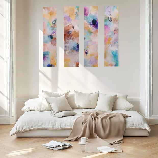 Bedroom with a bed, pillows, and a blanket, featuring four colorful abstract paintings on the wall.