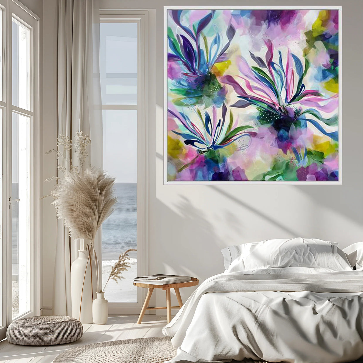 Colorful floral painting on a wall in a bedroom with natural light.