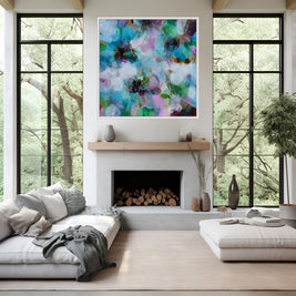 Modern living room with a fireplace, colorful abstract painting, and large windows.