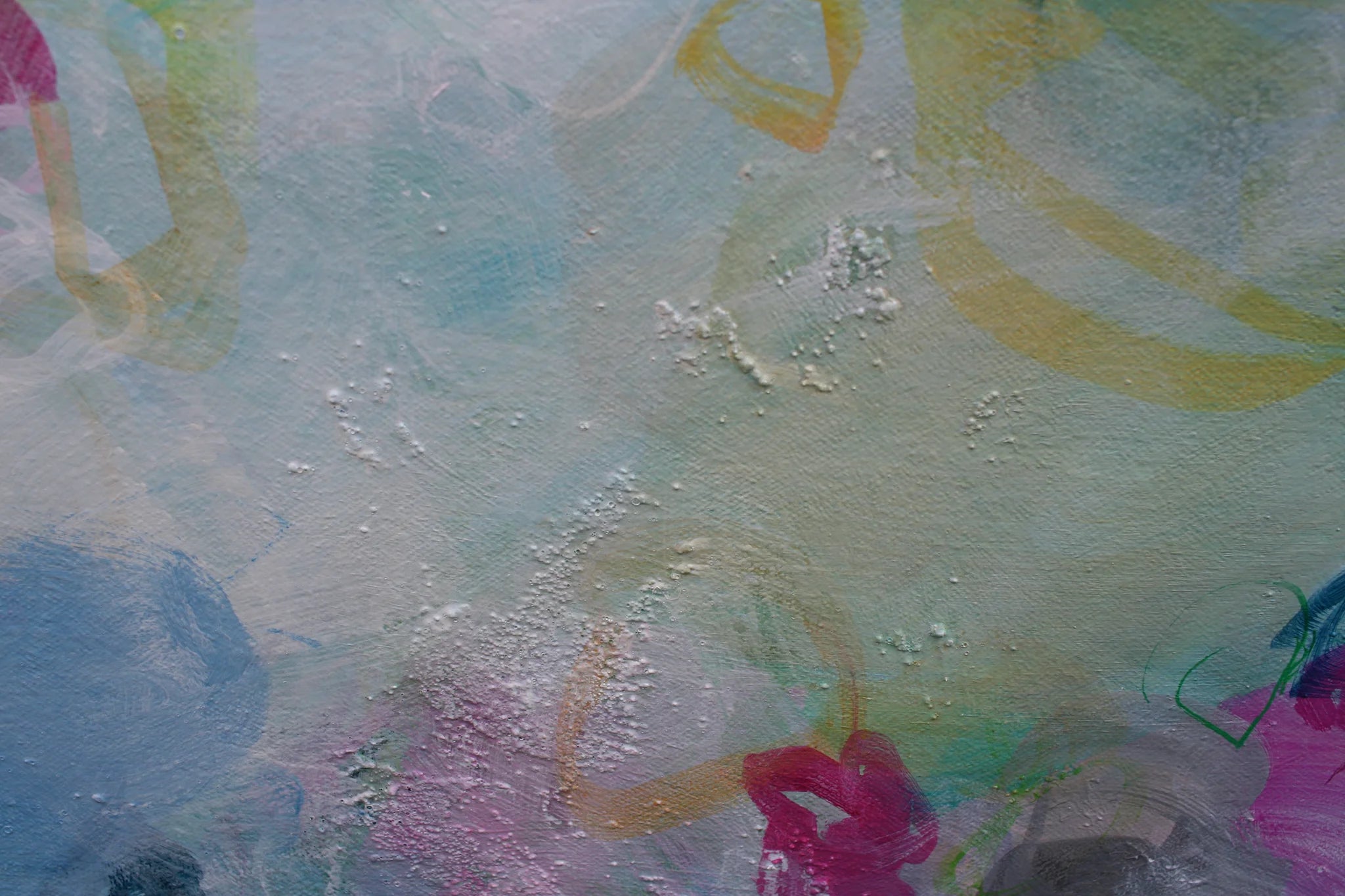 Abstract artwork with colorful brush strokes on a textured surface