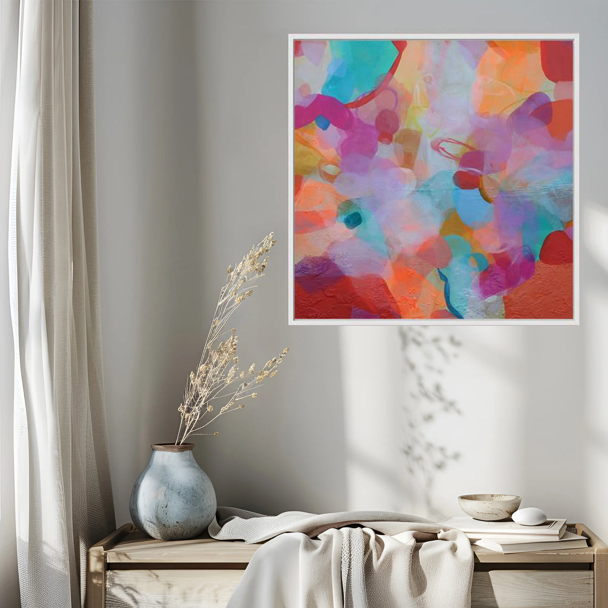 Colorful abstract painting on a wall above a wooden bench with decorative items.