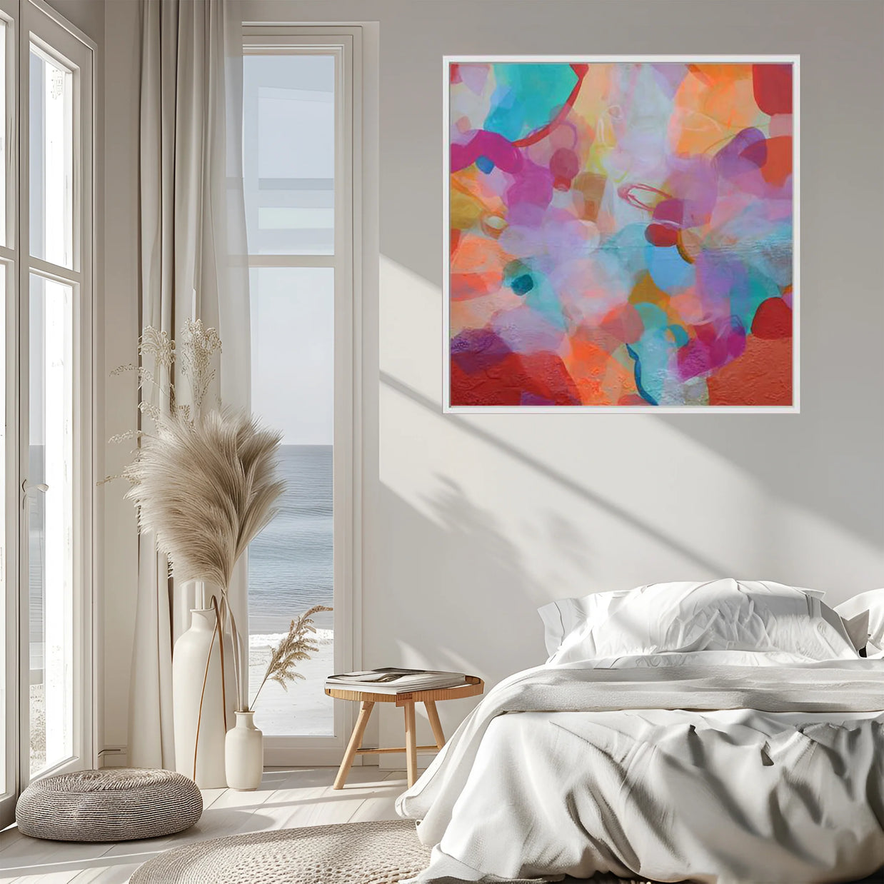 Colorful abstract painting on a wall above a bed in a bright room with large windows.