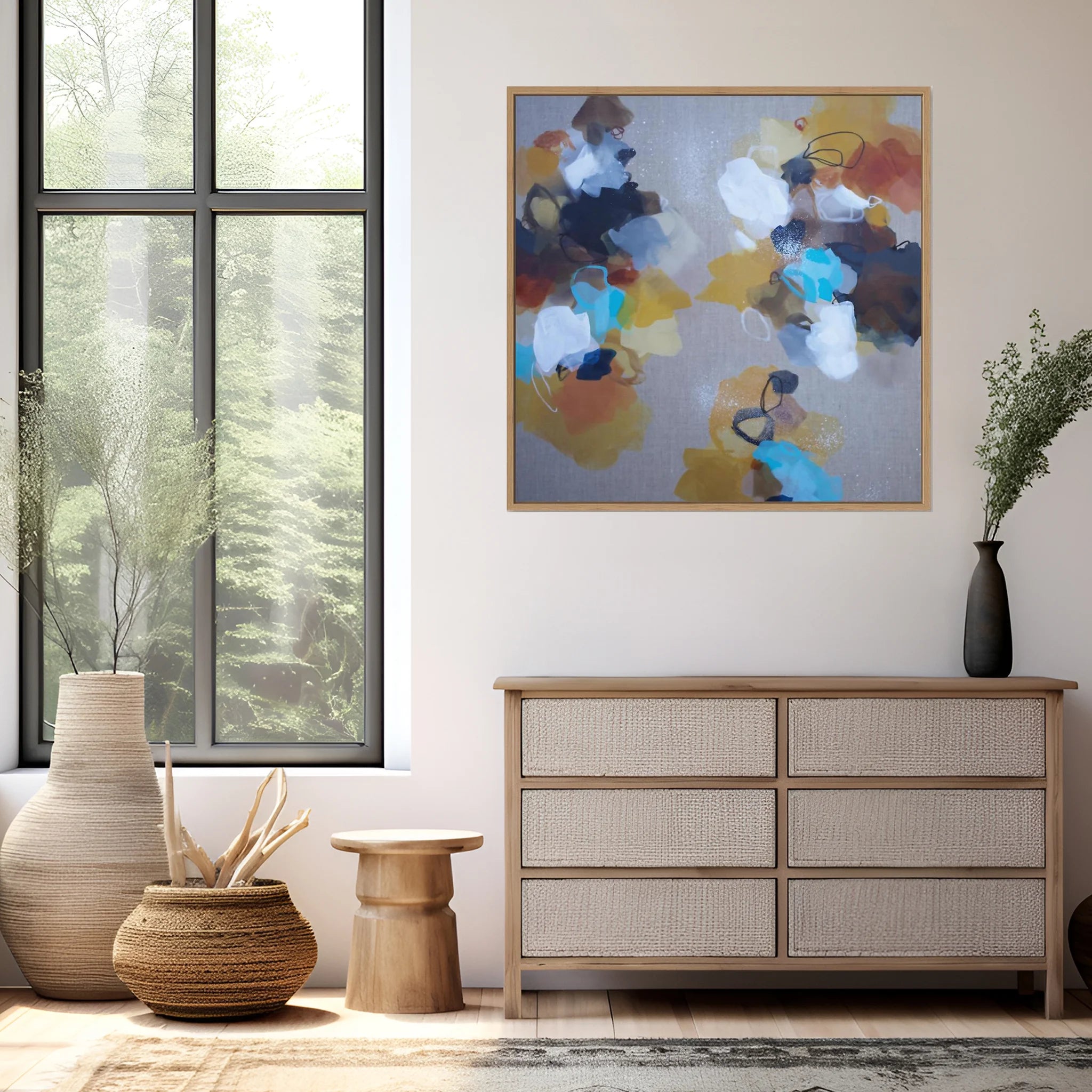 Modern interior with a dresser, abstract painting, and decorative items.