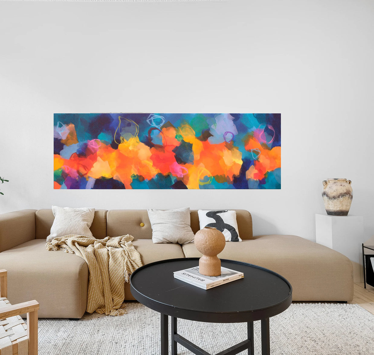 Colourful abstract painting above sofa