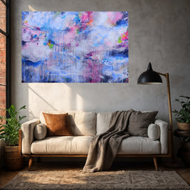 Living room with a colorful abstract painting above a beige sofa.