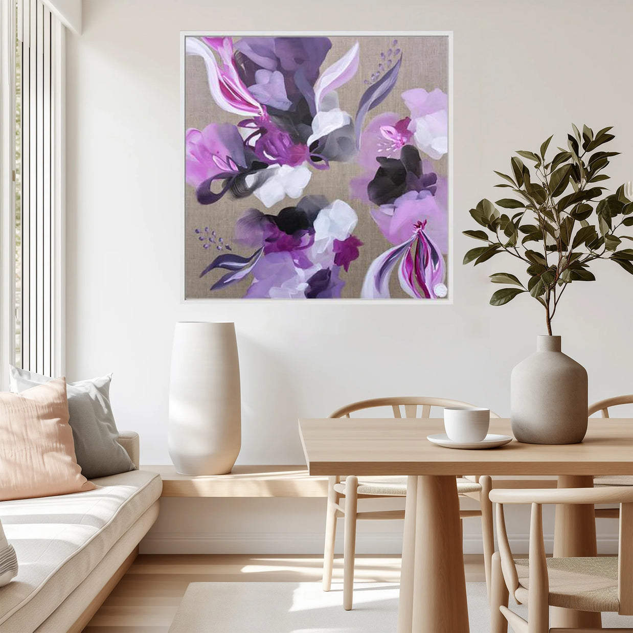Living room with a floral painting on the wall, a table with a plant, and a couch.