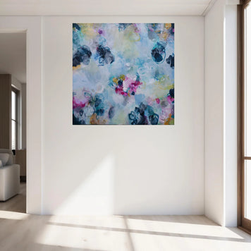 Colorful abstract painting on a white wall in a modern living room.