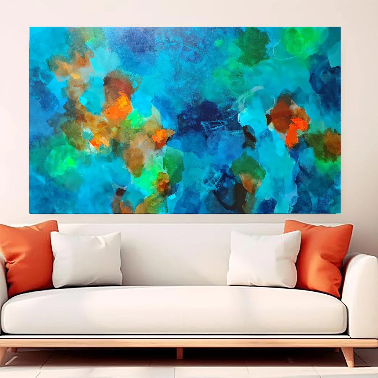 Colorful abstract painting on a wall above a white sofa with orange and white cushions.