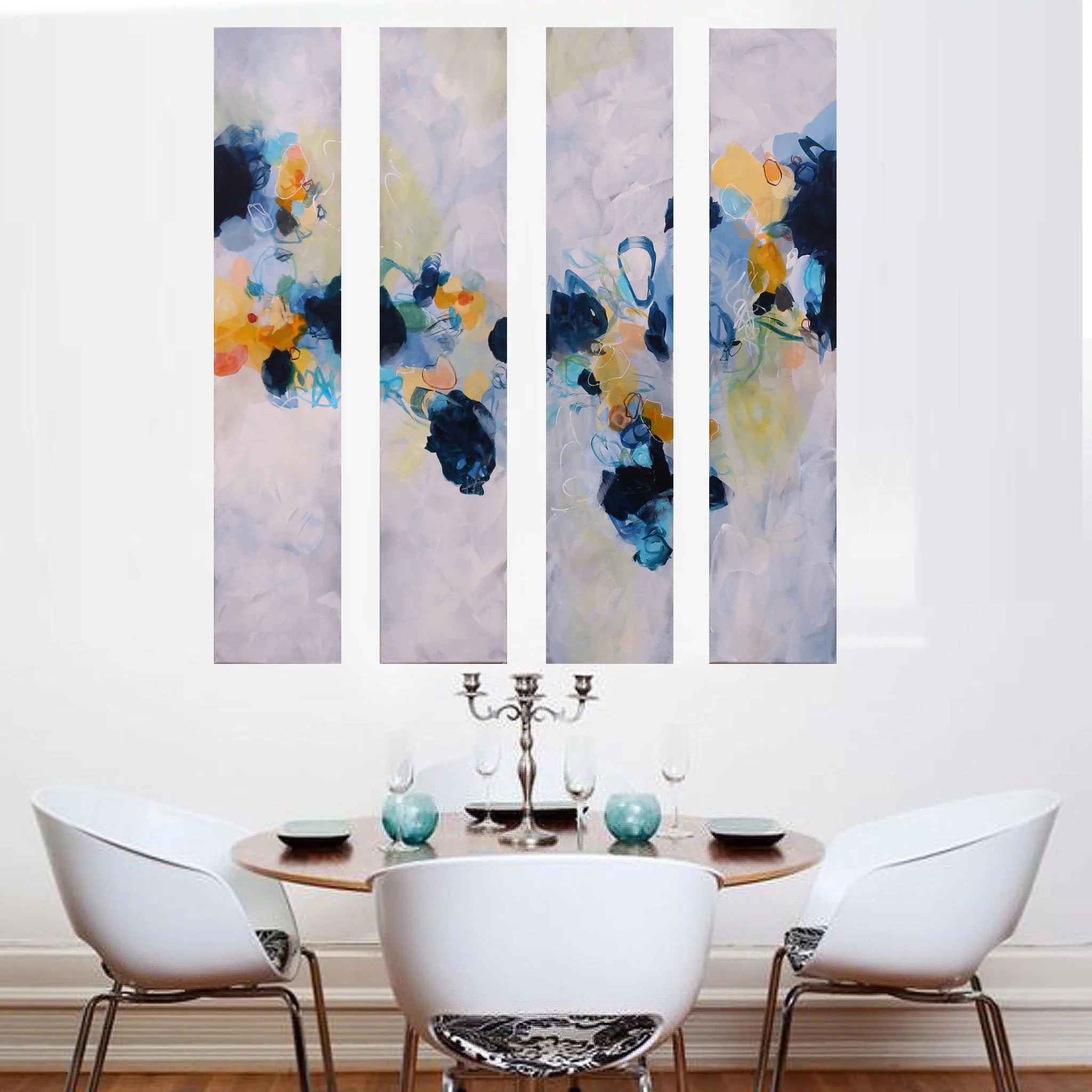 Colourful blue yellow white and greay four panel abstract painting above dining table and chairs
