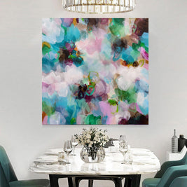 Dining room with a colorful abstract painting on the wall above a table set for four.