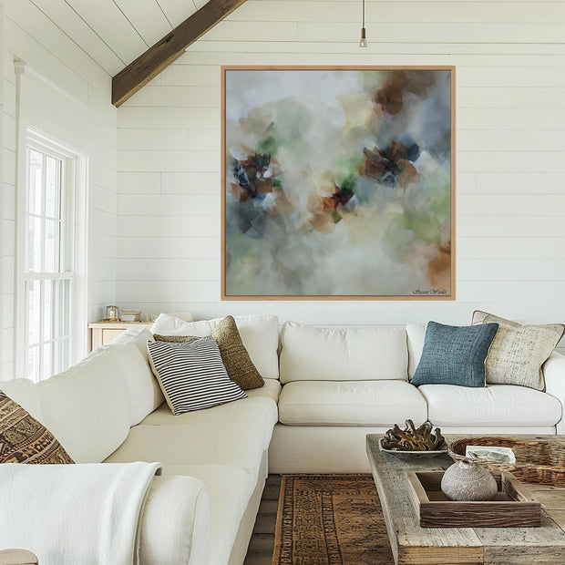 Living room with a white sofa, decorative pillows, and a large abstract painting on the wall.