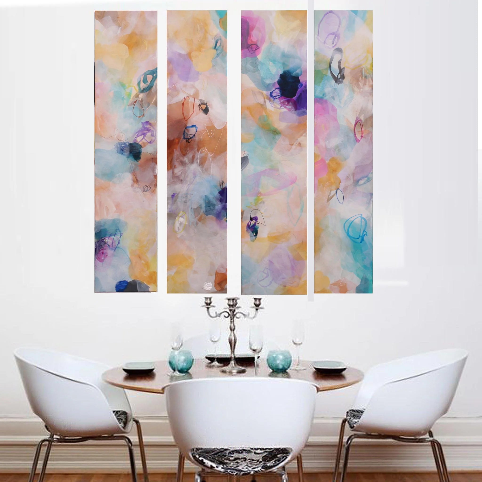 Colorful abstract wall art above a dining table with chairs.