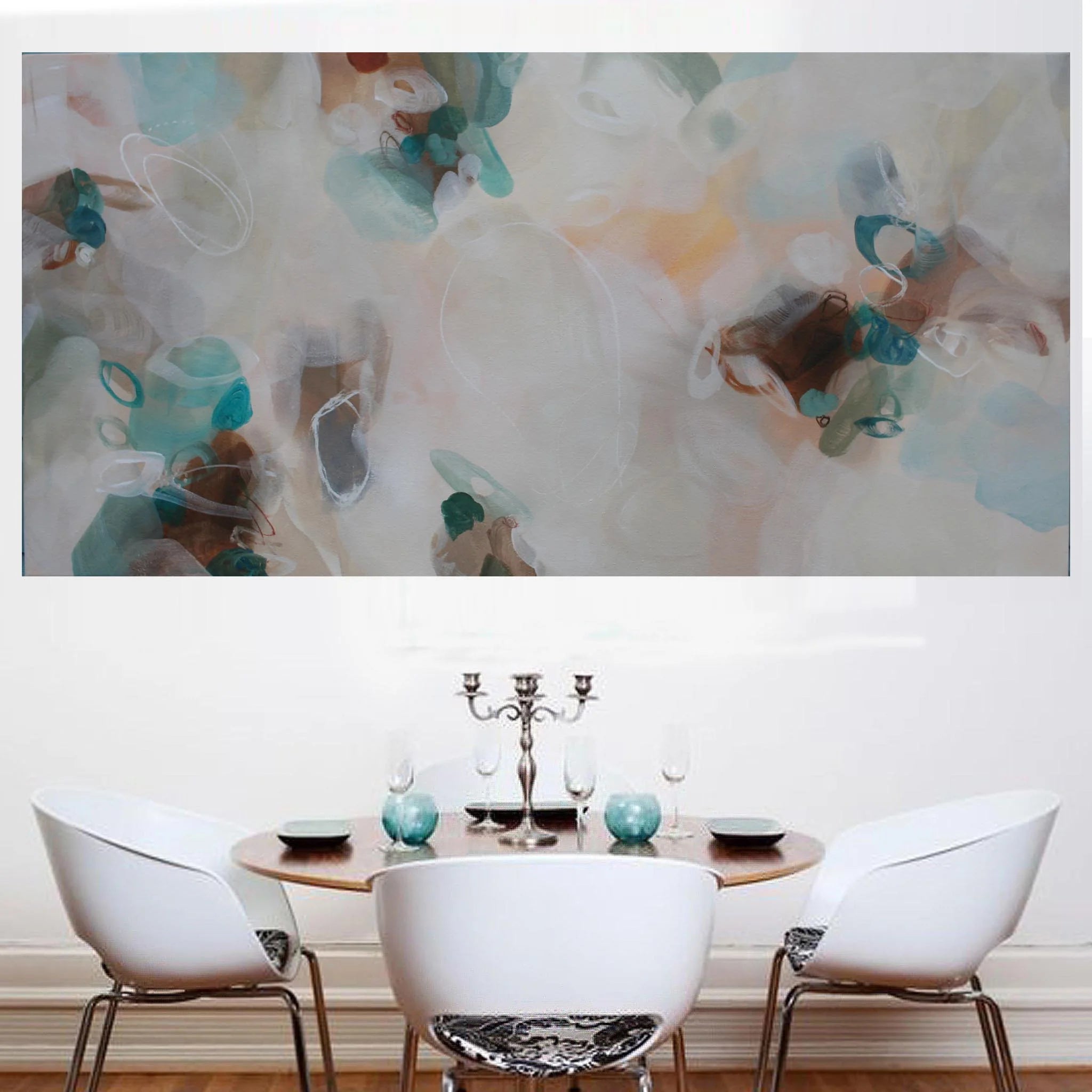 Dining room with a round table and chairs, featuring an abstract painting on the wall.