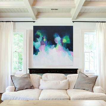 Living room with a white sofa, colorful abstract painting above the fireplace, and white curtains.