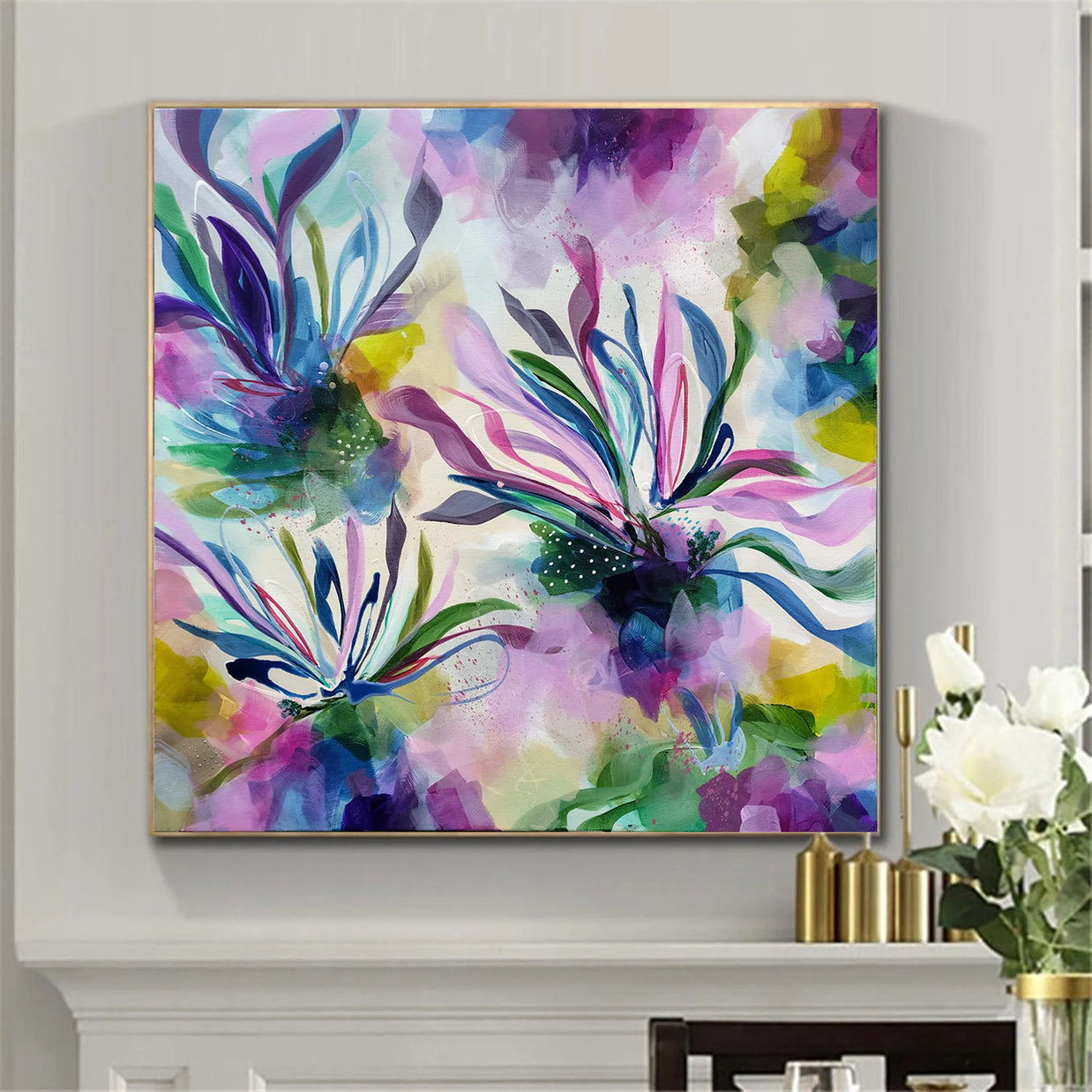 Colorful abstract painting on a wall with a vase of flowers in the corner.