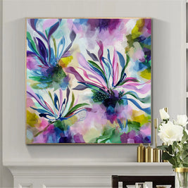 Colorful abstract painting on a wall with a vase of flowers in the corner.