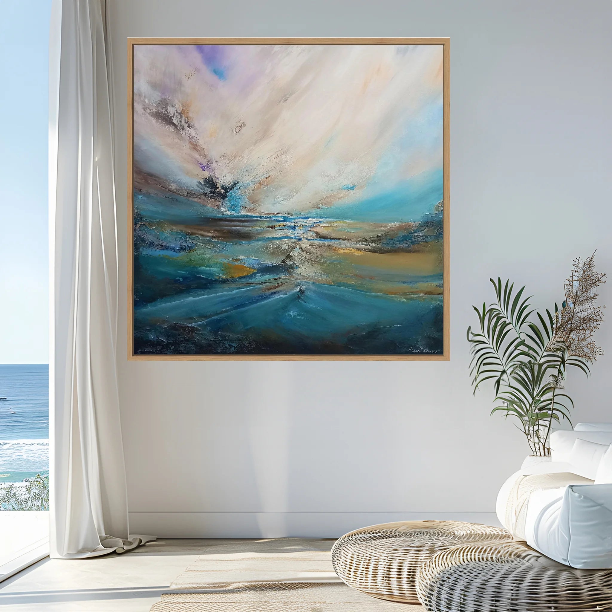 Abstract painting on a wall with a coastal view outside a window.