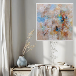 Abstract painting on a wall above a wooden bench with decorative items.