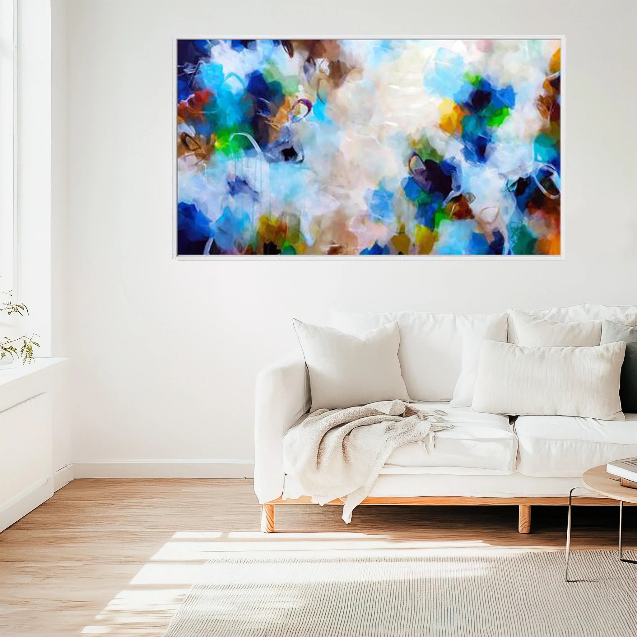 Living room with a white sofa and abstract multicolored painting on the wall.
