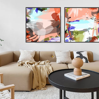 Living room with a beige sectional sofa, round black coffee table, and abstract art on the wall.