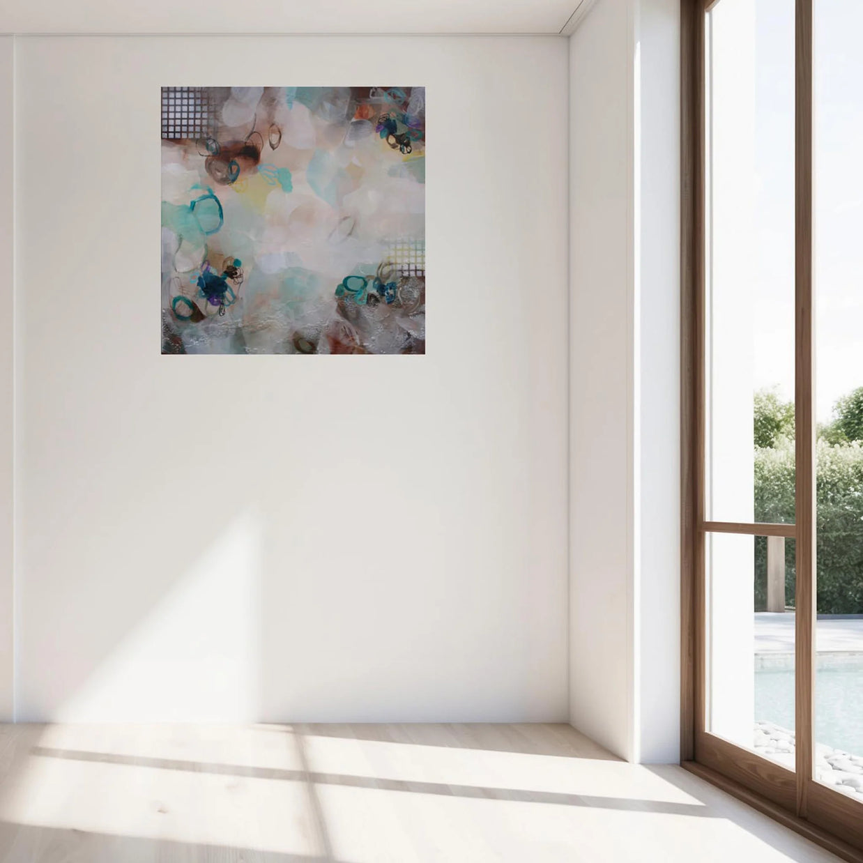 Abstract painting on a white wall with a large window in the background
