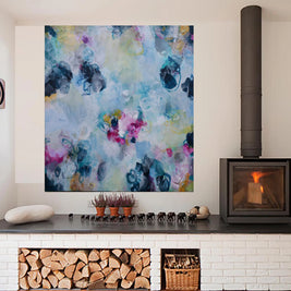 Colorful abstract painting on a wall above a fireplace with decorative elements.