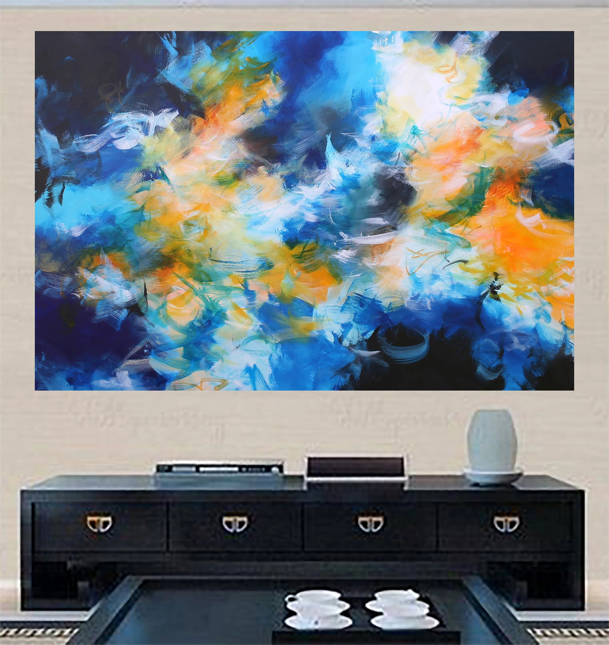 Abstract painting with blue, orange, and white colors on a wall above a black entertainment console.