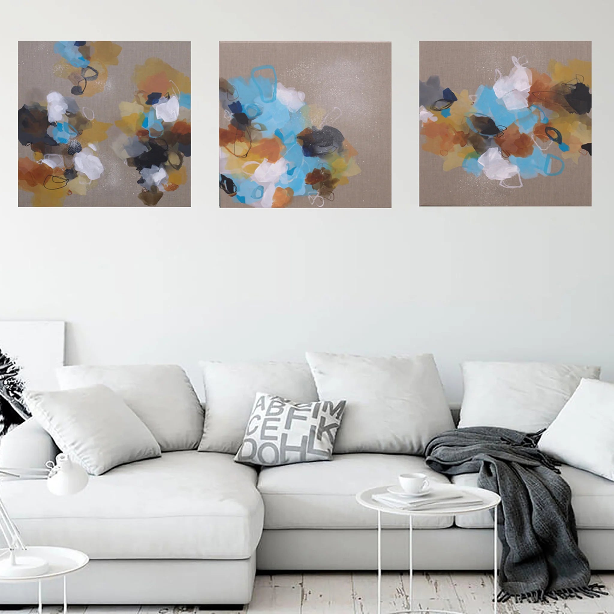 Three side-by-side images of colorful abstract art on a linen canvas background above sofa