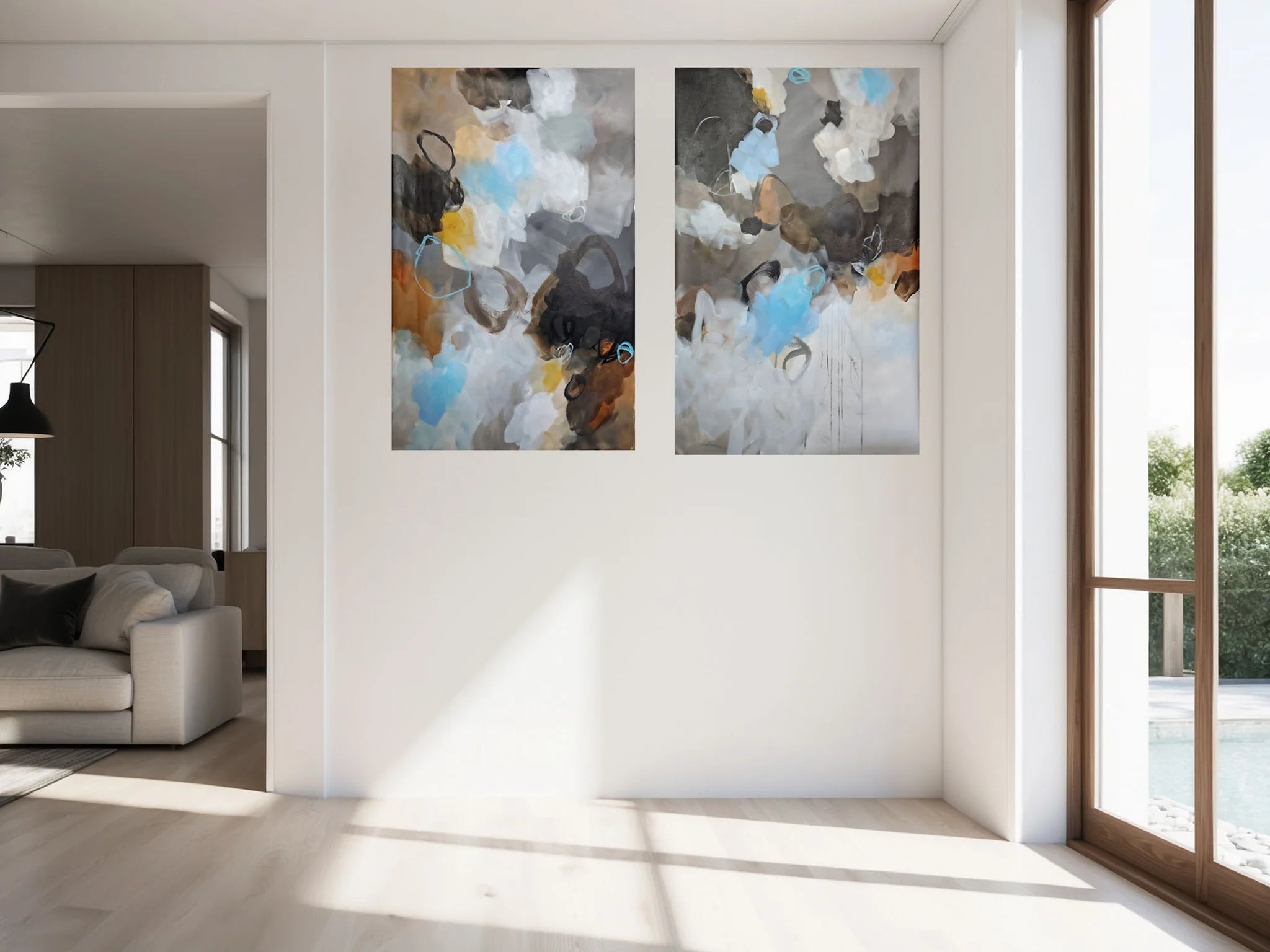 Two abstract paintings on a wall in a modern living room.