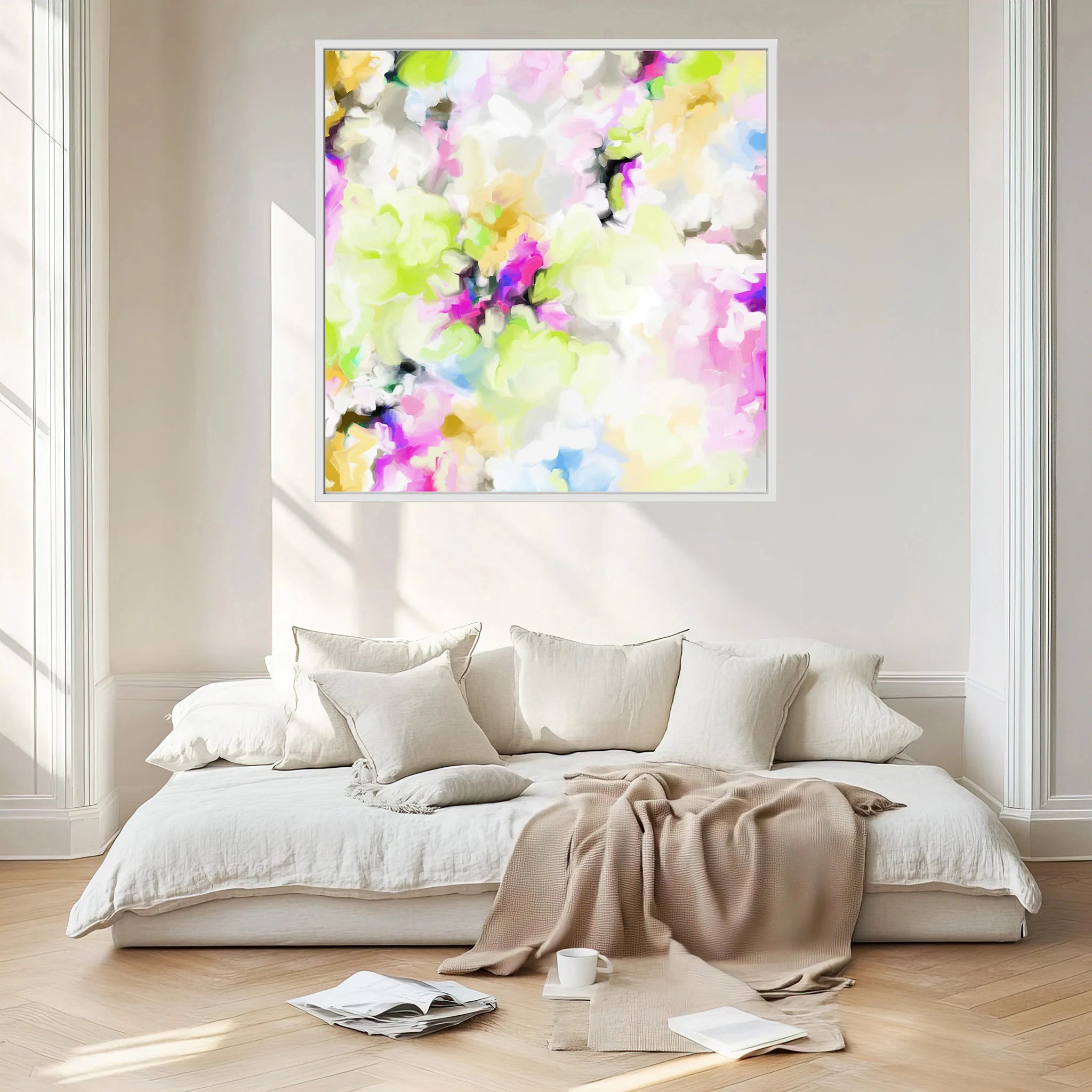Colorful abstract painting on a white wall above a bed with pillows and a blanket.