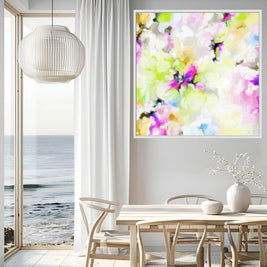 Modern interior with a colorful abstract painting on the wall, a dining table, and ocean view.